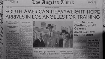 Movie still from “The Harder They Fall” (1956), directed by Mark Robson – An old photo of three men standing on top of a boat; Medium shot, High angle