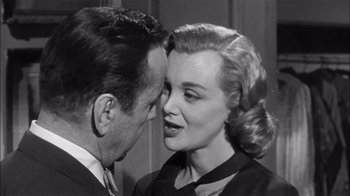 Movie still from “The Harder They Fall” (1956), directed by Mark Robson – A man and a woman face to face in a black and white photo; Close Up shot, Over the shoulder angle
