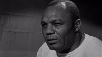 Movie still from “The Harder They Fall” (1956), directed by Mark Robson – A black and white photo of a man crying; Close Up shot, Low angle