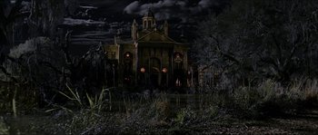 Movie still from “The Haunted Mansion” (2003), directed by Rob Minkoff – An old house with a lot of lights in the windows; Extreme Wide shot, Low angle