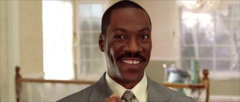 Movie still from “The Haunted Mansion” (2003), directed by Rob Minkoff – A person wearing a suit and tie; Close Up shot, Low angle