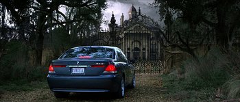 Movie still from “The Haunted Mansion” (2003), directed by Rob Minkoff – A car parked in front of an old cemetery; Wide shot, Low angle