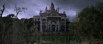 Movie still from “The Haunted Mansion” (2003), directed by Rob Minkoff – An old building with a pond in front of it; Extreme Wide shot, Low angle