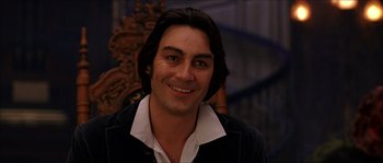 Movie still from “The Haunted Mansion” (2003), directed by Rob Minkoff – A person smiling for the camera; Close Up shot, Over the shoulder angle