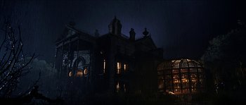 Movie still from “The Haunted Mansion” (2003), directed by Rob Minkoff – A large building in the dark at night time; Extreme Wide shot, Low angle