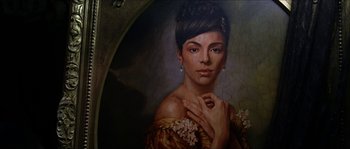 Movie still from “The Haunted Mansion” (2003), directed by Rob Minkoff – A painting of a beautiful woman in a yellow dress; Close Up shot, Low angle