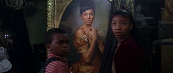 Movie still from “The Haunted Mansion” (2003), directed by Rob Minkoff – Two young children standing in front of a painting; Close Up shot, Low angle