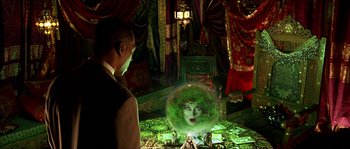 Movie still from “The Haunted Mansion” (2003), directed by Rob Minkoff – A man standing in front of a crystal ball; Medium shot, Over the shoulder angle