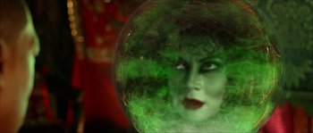 Movie still from “The Haunted Mansion” (2003), directed by Rob Minkoff – A woman with green hair is in a glass ball; Close Up shot, Over the shoulder angle