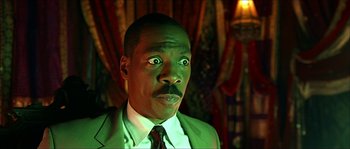 Movie still from “The Haunted Mansion” (2003), directed by Rob Minkoff – A person wearing a suit and tie; Close Up shot, Low angle