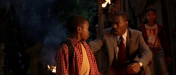 Movie still from “The Haunted Mansion” (2003), directed by Rob Minkoff – A man in a suit and tie pointing at a boy in a plaid shirt; Medium shot, Over the shoulder angle