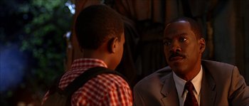 Movie still from “The Haunted Mansion” (2003), directed by Rob Minkoff – A man and a boy are talking to each other; Close Up shot, Over the shoulder angle