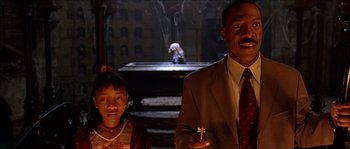 Movie still from “The Haunted Mansion” (2003), directed by Rob Minkoff – A man and a little girl standing next to each other; Medium shot, Low angle