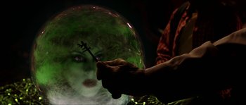 Movie still from “The Haunted Mansion” (2003), directed by Rob Minkoff – A person holding a key in front of a mirror; Close Up shot, Over the shoulder angle
