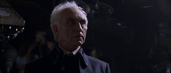 Movie still from “The Haunted Mansion” (2003), directed by Rob Minkoff – An older man with a white hair holding an umbrella; Close Up shot, Low angle