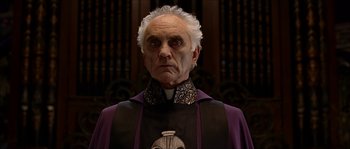 Movie still from “The Haunted Mansion” (2003), directed by Rob Minkoff – An old man in a priest's outfit; Close Up shot, Low angle