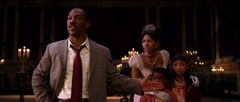 Movie still from “The Haunted Mansion” (2003), directed by Rob Minkoff – A man and a woman and a child in a room; Medium shot, Low angle