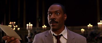 Movie still from “The Haunted Mansion” (2003), directed by Rob Minkoff – A person wearing a suit and tie; Close Up shot, Low angle