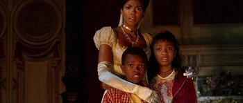 Movie still from “The Haunted Mansion” (2003), directed by Rob Minkoff – A woman and two children posing for a picture; Close Up shot, Low angle