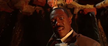 Movie still from “The Haunted Mansion” (2003), directed by Rob Minkoff – A person wearing a suit and tie; Close Up shot, Overhead angle