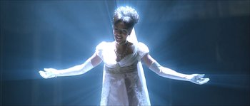 Movie still from “The Haunted Mansion” (2003), directed by Rob Minkoff – A woman in a white dress and white gloves; Medium shot, Low angle