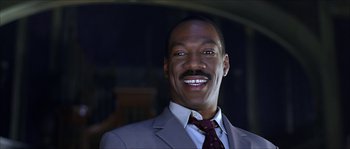 Movie still from “The Haunted Mansion” (2003), directed by Rob Minkoff – A person wearing a suit and tie; Close Up shot, Low angle