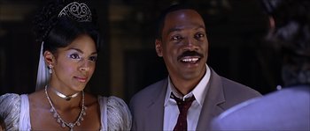 Movie still from “The Haunted Mansion” (2003), directed by Rob Minkoff – A man and a woman posing for a picture; Close Up shot, Low angle