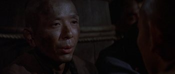 Movie still from “The Hawaiians” (1970), directed by Tom Gries – A person wearing a black shirt; Close Up shot, Over the shoulder angle