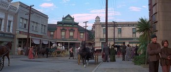 Movie still from “The Hawaiians” (1970), directed by Tom Gries – A horse drawn carriage on a city street; Extreme Wide shot, High angle