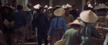Movie still from “The Hawaiians” (1970), directed by Tom Gries – A group of people wearing asian hats in a crowd; Wide shot, High angle