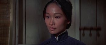 Movie still from “The Hawaiians” (1970), directed by Tom Gries – A woman in a blue dress is looking at the camera; Close Up shot, High angle