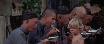 Movie still from “The Hawaiians” (1970), directed by Tom Gries – A group of men eating food from a bowl; Medium shot, High angle