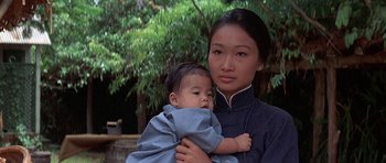 Movie still from “The Hawaiians” (1970), directed by Tom Gries – A woman holding a baby in her arms; Close Up shot, High angle
