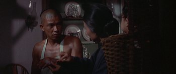 Movie still from “The Hawaiians” (1970), directed by Tom Gries – A man and a woman looking at another woman; Close Up shot, Over the shoulder angle