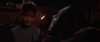 Movie still from “The Hawaiians” (1970), directed by Tom Gries – A man taking a picture of a woman in a dark room; Close Up shot, Over the shoulder angle