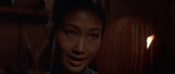 Movie still from “The Hawaiians” (1970), directed by Tom Gries – A young asian woman smiling for the camera; Close Up shot, Over the shoulder angle