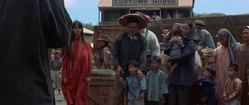 Movie still from “The Hawaiians” (1970), directed by Tom Gries – A group of people standing next to each other on a street; Wide shot, Low angle