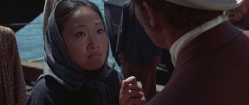 Movie still from “The Hawaiians” (1970), directed by Tom Gries – A woman sitting next to a man on a boat; Close Up shot, Over the shoulder angle