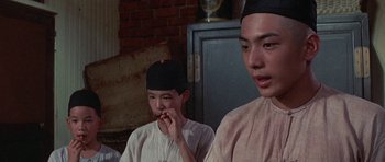 Movie still from “The Hawaiians” (1970), directed by Tom Gries – Two young men sitting next to each other in a room; Close Up shot, Low angle