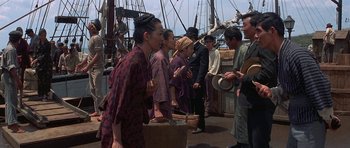 Movie still from “The Hawaiians” (1970), directed by Tom Gries – A group of people standing on top of a boat; Medium shot, Over the shoulder angle