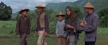 Movie still from “The Hawaiians” (1970), directed by Tom Gries – A man and a woman and a boy wearing hats; Medium shot, High angle