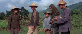 Movie still from “The Hawaiians” (1970), directed by Tom Gries – A group of people standing next to each other on top of a field; Wide shot, Low angle