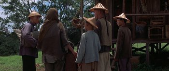 Movie still from “The Hawaiians” (1970), directed by Tom Gries – A group of people standing next to each other wearing hats; Wide shot, Over the shoulder angle