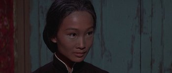 Movie still from “The Hawaiians” (1970), directed by Tom Gries – A young woman with dark hair wearing a black shirt; Close Up shot, High angle