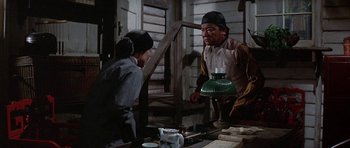 Movie still from “The Hawaiians” (1970), directed by Tom Gries – An older man and a young woman are talking in a room; Medium shot, Over the shoulder angle