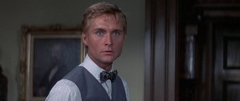 Movie still from “The Hawaiians” (1970), directed by Tom Gries – A person wearing a vest and a bow tie; Close Up shot, Low angle