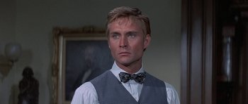 Movie still from “The Hawaiians” (1970), directed by Tom Gries – A person wearing a vest and a bow tie; Close Up shot, Low angle