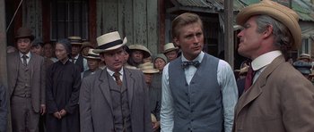 Movie still from “The Hawaiians” (1970), directed by Tom Gries – A group of men standing next to each other wearing hats; Close Up shot, Low angle