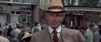 Movie still from “The Hawaiians” (1970), directed by Tom Gries – A person wearing a suit and a hat; Close Up shot, Over the shoulder angle