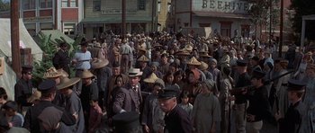 Movie still from “The Hawaiians” (1970), directed by Tom Gries – A large group of people are walking down the street; Wide shot, High angle